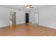 Bedroom with hardwood flooring featuring doorways and a door to the exterior of the home at 204 Lori Ct, Umatilla, FL 32784