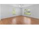 Bedroom featuring hardwood flooring, two windows, and natural light at 204 Lori Ct, Umatilla, FL 32784