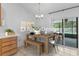 Dining area with wooden table and chairs, offers seamless access to the outdoor pool area at 204 Lori Ct, Umatilla, FL 32784