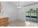 Dining area with tile floors, sliding glass doors to screened patio and a chandelier at 204 Lori Ct, Umatilla, FL 32784