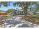 Charming one-story home with a curved driveway, manicured lawn, and privacy fence at 204 Lori Ct, Umatilla, FL 32784