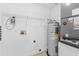 Functional laundry area with water heater, storage shelving, and connections for washer and dryer at 204 Lori Ct, Umatilla, FL 32784