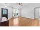 Bright and airy living room features wood flooring, a ceiling fan, and plenty of natural light at 204 Lori Ct, Umatilla, FL 32784