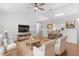 Staged living room with hardwood floors, a ceiling fan, and neutral colors at 204 Lori Ct, Umatilla, FL 32784