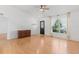 Spacious living room with hardwood floors, a front door, a large window and neutral-colored walls at 204 Lori Ct, Umatilla, FL 32784