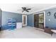 Inside of the screened enclosure showing a ceiling fan, sliding door, dart board and outdoor access at 204 Lori Ct, Umatilla, FL 32784