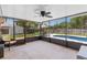 Spacious screened enclosure with a ceiling fan, offering a comfortable outdoor living space at 204 Lori Ct, Umatilla, FL 32784