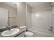 A bathroom features a vanity, toilet, shower with a curtain, and a neutral color scheme at 2207 Crawford Ct, The Villages, FL 32162