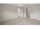 A spacious bedroom features neutral walls, carpeted flooring, and white doors providing entry to other rooms at 2207 Crawford Ct, The Villages, FL 32162