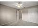 A bedroom featuring a neutral palette, ceiling fan, and closet, offering a simple and inviting space at 2207 Crawford Ct, The Villages, FL 32162