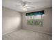 Bright bedroom features a ceiling fan and window view, offering a comfortable living space at 2207 Crawford Ct, The Villages, FL 32162