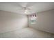 A bright bedroom featuring neutral walls, a ceiling fan, and a window bringing in natural light at 2207 Crawford Ct, The Villages, FL 32162