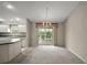 Open dining room with sliding doors to the backyard patio and neutral colors and adjacent to kitchen at 2207 Crawford Ct, The Villages, FL 32162