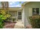 Inviting screened entrance, mature landscaping, and covered front porch at 2207 Crawford Ct, The Villages, FL 32162