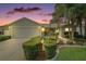 Charming home with well-maintained landscaping, palm trees and attached two-car garage at 2207 Crawford Ct, The Villages, FL 32162