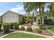 Well-maintained home with lush landscaping, a two-car garage, and a welcoming entryway at 2207 Crawford Ct, The Villages, FL 32162