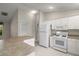 Bright kitchen featuring white appliances, countertops, and ample cabinet space at 2207 Crawford Ct, The Villages, FL 32162