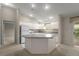 Bright kitchen featuring white appliances, countertops, and ample cabinet space at 2207 Crawford Ct, The Villages, FL 32162