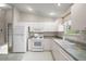 Bright kitchen featuring white appliances, countertops, and ample cabinet space at 2207 Crawford Ct, The Villages, FL 32162