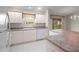 Bright kitchen featuring white appliances, countertops, and ample cabinet space at 2207 Crawford Ct, The Villages, FL 32162