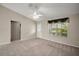 Bright living room features vaulted ceilings, large window, neutral paint, and great natural light at 2207 Crawford Ct, The Villages, FL 32162