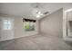 Bright living room features vaulted ceilings, large window, neutral paint, and great natural light at 2207 Crawford Ct, The Villages, FL 32162