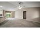 Living room view to the backyard, kitchen and a neutral decor and vaulted ceiling at 2207 Crawford Ct, The Villages, FL 32162