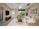 Bright living room featuring a comfortable sofa, ceiling fan, and large window with a view to the exterior at 2207 Crawford Ct, The Villages, FL 32162