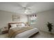 Comfortable bedroom featuring soft lighting, window with a view and decorative headboard at 2207 Crawford Ct, The Villages, FL 32162