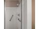 A well-maintained shower features grab bars, a shower head, and shelving for toiletries at 2207 Crawford Ct, The Villages, FL 32162