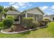 The cozy sunroom features screened windows with views of the well-manicured lawn and exterior landscaping at 2207 Crawford Ct, The Villages, FL 32162