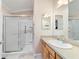 Clean bathroom features a walk-in shower and a vanity with ample counter space, offering convenience at 2237 Jetta Way, The Villages, FL 32162