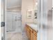 Well-lit bathroom features a convenient walk-in shower, modern fixtures, and a vanity at 2237 Jetta Way, The Villages, FL 32162