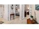 Hallway with view into primary bedroom featuring hardwood floors and ceiling fan at 2237 Jetta Way, The Villages, FL 32162