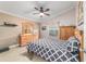 Inviting bedroom with a neutral color scheme, wooden furniture, and a ceiling fan at 2237 Jetta Way, The Villages, FL 32162