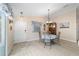 Charming dining area with a round table, wood floors, and natural light filtering through the window at 2237 Jetta Way, The Villages, FL 32162