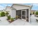 Single-story home featuring a screen patio, tasteful landscaping, and a well-maintained exterior at 2237 Jetta Way, The Villages, FL 32162