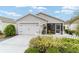 Well-maintained single-story home with a clean garage door, manicured lawn, and a decorative picket fence at 2237 Jetta Way, The Villages, FL 32162
