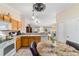 Kitchen featuring wooden cabinets, modern appliances, and an open view into the living room at 2237 Jetta Way, The Villages, FL 32162