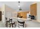 Kitchen featuring a breakfast bar, pendant lighting, a dining table, and updated appliances at 2237 Jetta Way, The Villages, FL 32162