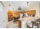 Well-lit kitchen featuring modern appliances, a breakfast bar, and a cozy dining nook at 2237 Jetta Way, The Villages, FL 32162