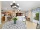 Inviting living space with a view of the kitchen, dining area, and comfortable seating, creating a warm and welcoming atmosphere at 2237 Jetta Way, The Villages, FL 32162