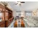 Inviting living room boasting a wooden entertainment center, plush seating, and ample natural light at 2237 Jetta Way, The Villages, FL 32162