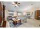 Welcoming living area featuring comfortable seating, a ceiling fan, and an adjacent dining space at 2237 Jetta Way, The Villages, FL 32162