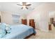Large bedroom featuring a ceiling fan, wooden furniture, and plenty of natural light at 2237 Jetta Way, The Villages, FL 32162