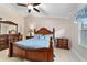 Cozy bedroom offers natural light, a ceiling fan, and wood furniture, creating a relaxing atmosphere at 2237 Jetta Way, The Villages, FL 32162