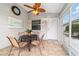 Cozy screened patio with tile flooring, ceiling fan, table, and chairs, perfect for outdoor dining and relaxation at 2237 Jetta Way, The Villages, FL 32162
