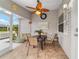 Cozy screened patio with tile flooring, ceiling fan, table, and chairs, perfect for outdoor relaxation at 2237 Jetta Way, The Villages, FL 32162