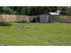 Spacious backyard with a fire pit, shed, and ample room for activities at 235 Rockmoore Ct, Deland, FL 32720
