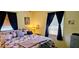 Comfortable bedroom with a patchwork quilt and soft window light at 235 Rockmoore Ct, Deland, FL 32720
